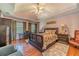 Spacious main bedroom offers a tray ceiling, hardwood floors, and large windows at 4105 Vicksburg Dr, Lawrenceville, GA 30044