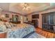 Cozy main bedroom with tray ceiling, hardwood floors, TV, and a large bed at 4105 Vicksburg Dr, Lawrenceville, GA 30044