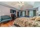 Spacious main bedroom with tray ceilings, fan, hardwood floors, and sitting area at 4105 Vicksburg Dr, Lawrenceville, GA 30044