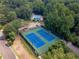 Aerial view of tennis courts and community pool surrounded by mature trees, perfect for recreation and relaxation at 4105 Vicksburg Dr, Lawrenceville, GA 30044