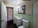 Well-lit bathroom featuring a vanity with a framed mirror and retro green tile at 510 Se Boyds Se Dr, Marietta, GA 30067