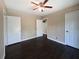 Comfortable bedroom with dark hardwood floors, ceiling fan and three doors at 510 Se Boyds Se Dr, Marietta, GA 30067