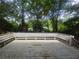 Large wooden deck with built-in benches and views of surrounding trees at 510 Se Boyds Se Dr, Marietta, GA 30067