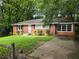 Charming brick home with manicured lawn, black shutters, and a cozy, inviting appeal at 510 Se Boyds Se Dr, Marietta, GA 30067