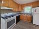 Functional kitchen with wooden cabinets, a black dishwasher, and modern gray vinyl flooring at 510 Se Boyds Se Dr, Marietta, GA 30067