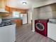 Well-equipped kitchen with wooden cabinets, appliances and a modern red front-loading washer at 510 Se Boyds Se Dr, Marietta, GA 30067