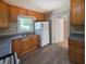 Kitchen featuring wooden cabinets, white appliances and vinyl flooring at 510 Se Boyds Se Dr, Marietta, GA 30067