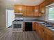 Functional kitchen with wooden cabinets, a black dishwasher, and a white oven at 510 Se Boyds Se Dr, Marietta, GA 30067