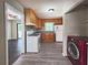 Well-lit kitchen featuring wooden cabinets, white appliances, and a red front loading washer at 510 Se Boyds Se Dr, Marietta, GA 30067