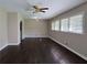Living room with hardwood floors, ceiling fan, and arched doorway leading to laundry room at 510 Se Boyds Se Dr, Marietta, GA 30067