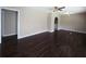 Spacious living room featuring hardwood floors and an arched doorway leading to a laundry room at 510 Se Boyds Se Dr, Marietta, GA 30067