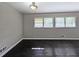 Bright living room featuring three windows, dark wood floors and neutral colored walls at 510 Se Boyds Se Dr, Marietta, GA 30067