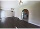 Living room featuring hardwood floors, arched doorway to kitchen with wooden cabinets and appliances at 510 Se Boyds Se Dr, Marietta, GA 30067