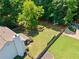 Aerial view of a private backyard with inground pool, garden, large yard and an outbuilding at 5340 Harris Creek Dr, Cumming, GA 30040