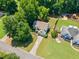 Aerial view of a home with a large front yard, well-maintained lawn, and mature trees at 5340 Harris Creek Dr, Cumming, GA 30040