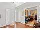 Bright foyer with hardwood floors and modern accents, leading into a sunlit living space, adjacent to the front door at 5340 Harris Creek Dr, Cumming, GA 30040