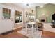 Bright eat-in kitchen flows to a large living room with stone fireplace and access to the screened porch from a door to the left at 5340 Harris Creek Dr, Cumming, GA 30040