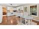 White kitchen with stainless appliances, wooden floors, and a door to the screened porch that offers an indoor-outdoor flow at 5340 Harris Creek Dr, Cumming, GA 30040