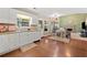 Bright eat-in kitchen with hardwood floors flows seamlessly into a large living room with stone fireplace at 5340 Harris Creek Dr, Cumming, GA 30040