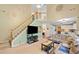 Bright living room with a staircase, modern TV setup, and open floor plan at 5340 Harris Creek Dr, Cumming, GA 30040