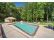 Backyard inground pool area surrounded by greenery and featuring an open-air shelter with seating at 5340 Harris Creek Dr, Cumming, GA 30040