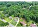 Aerial view showcases a tree-surrounded property with a charming home and expansive yard at 175 Hunters Gln, Fayetteville, GA 30215