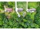 Overhead shot shows a property surrounded by lush trees with a well-maintained lawn and driveway at 175 Hunters Gln, Fayetteville, GA 30215