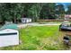 An elevated shot of the backyard with a large metal storage shed and mature trees at 175 Hunters Gln, Fayetteville, GA 30215