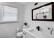 Elegant bathroom with modern fixtures, a sleek vanity, and a bright window, offering a refreshing and clean space at 175 Hunters Gln, Fayetteville, GA 30215