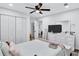 Well-lit bedroom with wood floors, a ceiling fan, and ample storage, perfect for a comfortable living space at 175 Hunters Gln, Fayetteville, GA 30215