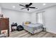 Cozy bedroom with a ceiling fan, wood floors, and a large window providing plenty of natural light at 175 Hunters Gln, Fayetteville, GA 30215