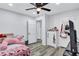 Comfortable bedroom featuring wood floors, a ceiling fan, and a bright, airy atmosphere for rest and relaxation at 175 Hunters Gln, Fayetteville, GA 30215