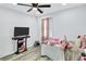 Spacious bedroom with a ceiling fan, wood floors, and a large window offering ample natural light and ventilation at 175 Hunters Gln, Fayetteville, GA 30215
