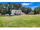 Spacious front yard highlights this lovely two-story home with a welcoming porch and traditional design at 175 Hunters Gln, Fayetteville, GA 30215