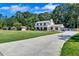 Beautiful two-story home featuring a long driveway, well-kept lawn, and inviting front porch at 175 Hunters Gln, Fayetteville, GA 30215