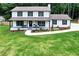 Charming two-story home with a welcoming front porch and manicured lawn at 175 Hunters Gln, Fayetteville, GA 30215
