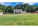 Expansive front lawn leads up to a charming two-story home with a welcoming front porch at 175 Hunters Gln, Fayetteville, GA 30215