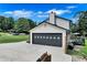 Exterior view of home garage with decorative window accents and a large concrete driveway at 175 Hunters Gln, Fayetteville, GA 30215