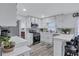 Bright kitchen featuring white cabinets, stainless steel appliances, and a breakfast bar with black stools at 175 Hunters Gln, Fayetteville, GA 30215