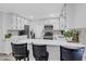 Updated kitchen with white cabinetry, stainless steel appliances, and a bar seating area perfect for casual dining at 175 Hunters Gln, Fayetteville, GA 30215