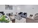 Inviting living room with modern decor, plush seating, and a stylish area rug at 175 Hunters Gln, Fayetteville, GA 30215