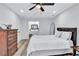 Bright main bedroom featuring a ceiling fan, wood floors, and an attached bathroom for added convenience at 175 Hunters Gln, Fayetteville, GA 30215