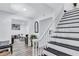 Entryway featuring a staircase with black treads and a white banister, leading to the upper level of the home at 175 Hunters Gln, Fayetteville, GA 30215