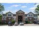 Exterior shot of the apartment building, showing the parking lot and some parked cars at 3303 Par Three Way, Lithonia, GA 30038