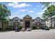 Exterior shot of the apartment building, showing the parking lot and some parked cars at 3303 Par Three Way, Lithonia, GA 30038