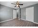 Spacious bedroom with wood-look floors and easy access to an adjoining hallway at 3303 Par Three Way, Lithonia, GA 30038