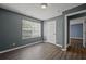 Charming bedroom featuring a sunny window and hard wood floors at 3303 Par Three Way, Lithonia, GA 30038