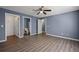 This bedroom has hardwood floors and multiple entryways to closet and bathroom at 3303 Par Three Way, Lithonia, GA 30038