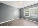 Inviting bedroom featuring a large window with natural light and wood-look flooring at 3303 Par Three Way, Lithonia, GA 30038