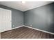 A bedroom featuring hardwood floors, neutral gray walls and a standard ceiling light fixture at 3303 Par Three Way, Lithonia, GA 30038